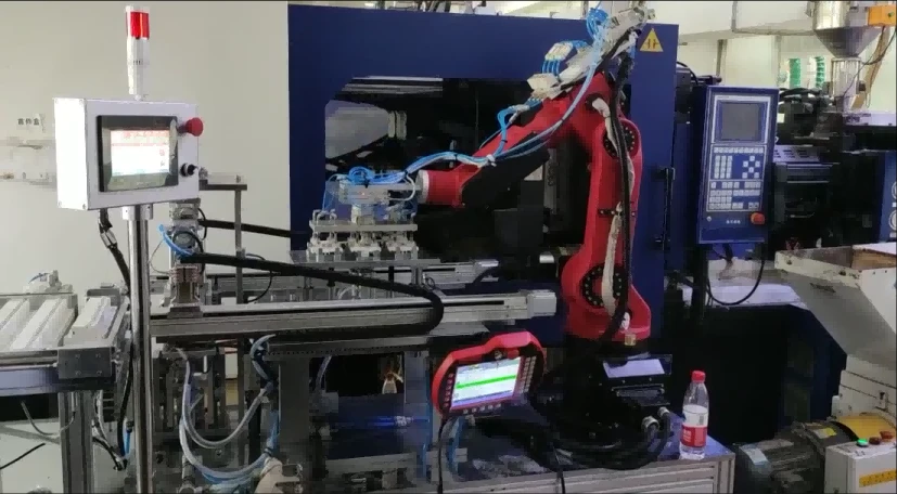 robot taking product from injection machine robot taking product from injection machine